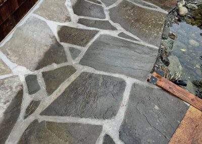 slate patio next to pond