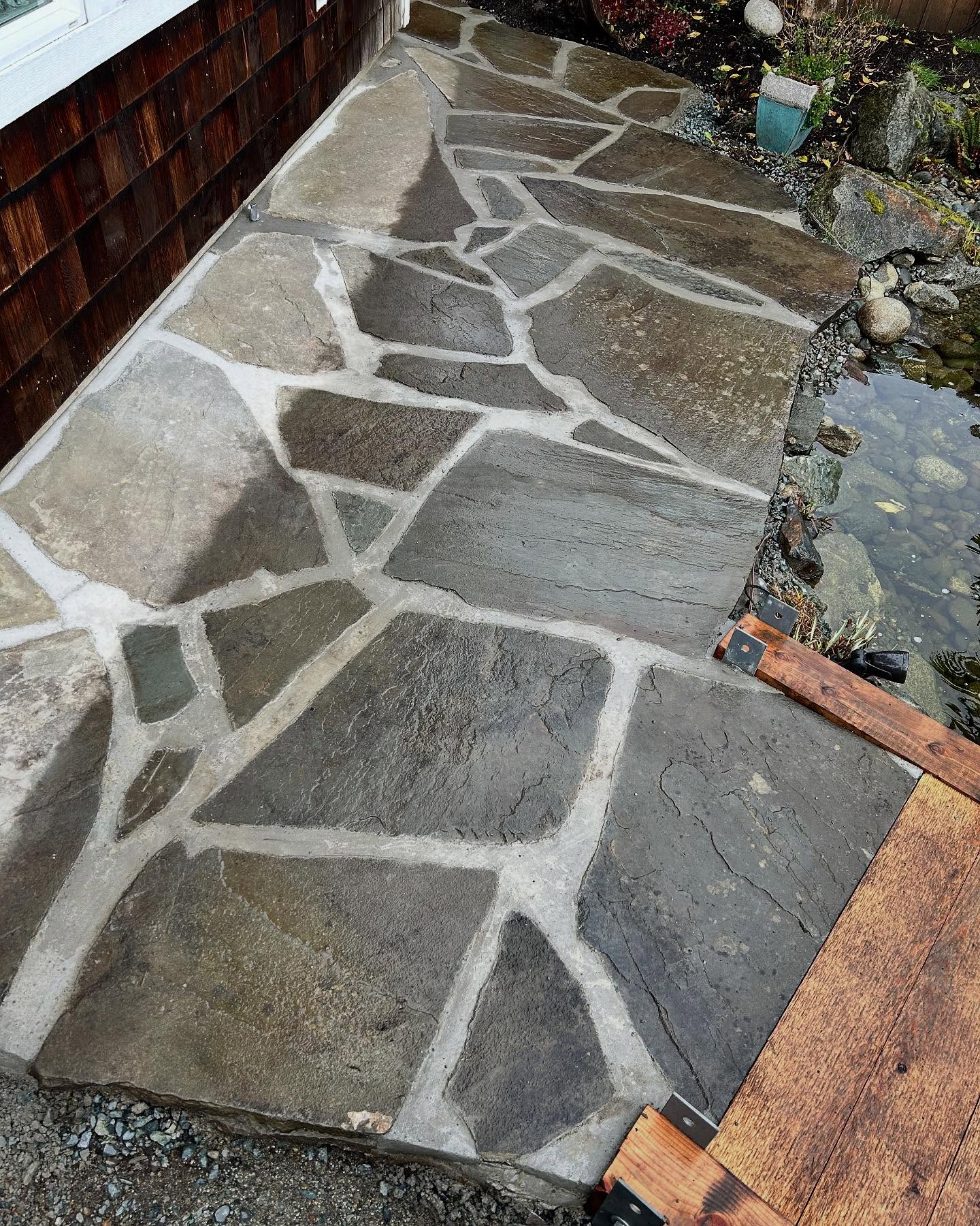 slate patio next to pond